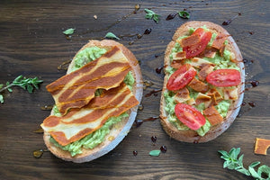 Nature's Choice Brunchin' Toast topped with smashed avocados, tomatoes, lime juice, EVOO, Nature's Choice plant-based bacon strips and drizzle of balsamic glaze. Toast with smashed avocados, Nature's Choice plant-based bacon strips and drizzle of honey.
