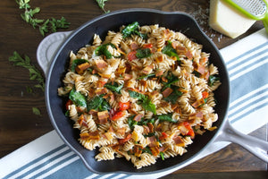 Nature's Choice one skillet pasta. Pasta with bursting cherry tomatoes, spinach, EVOO, garlic, chili flakes and the secret ingredient... lots of Nature's Choice plant-based bacon crumbled into bits.